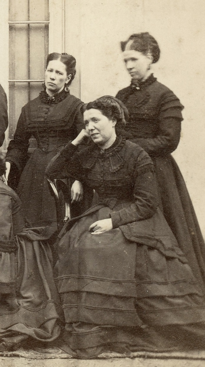Group in dark clothes, possibly Scottish 5
